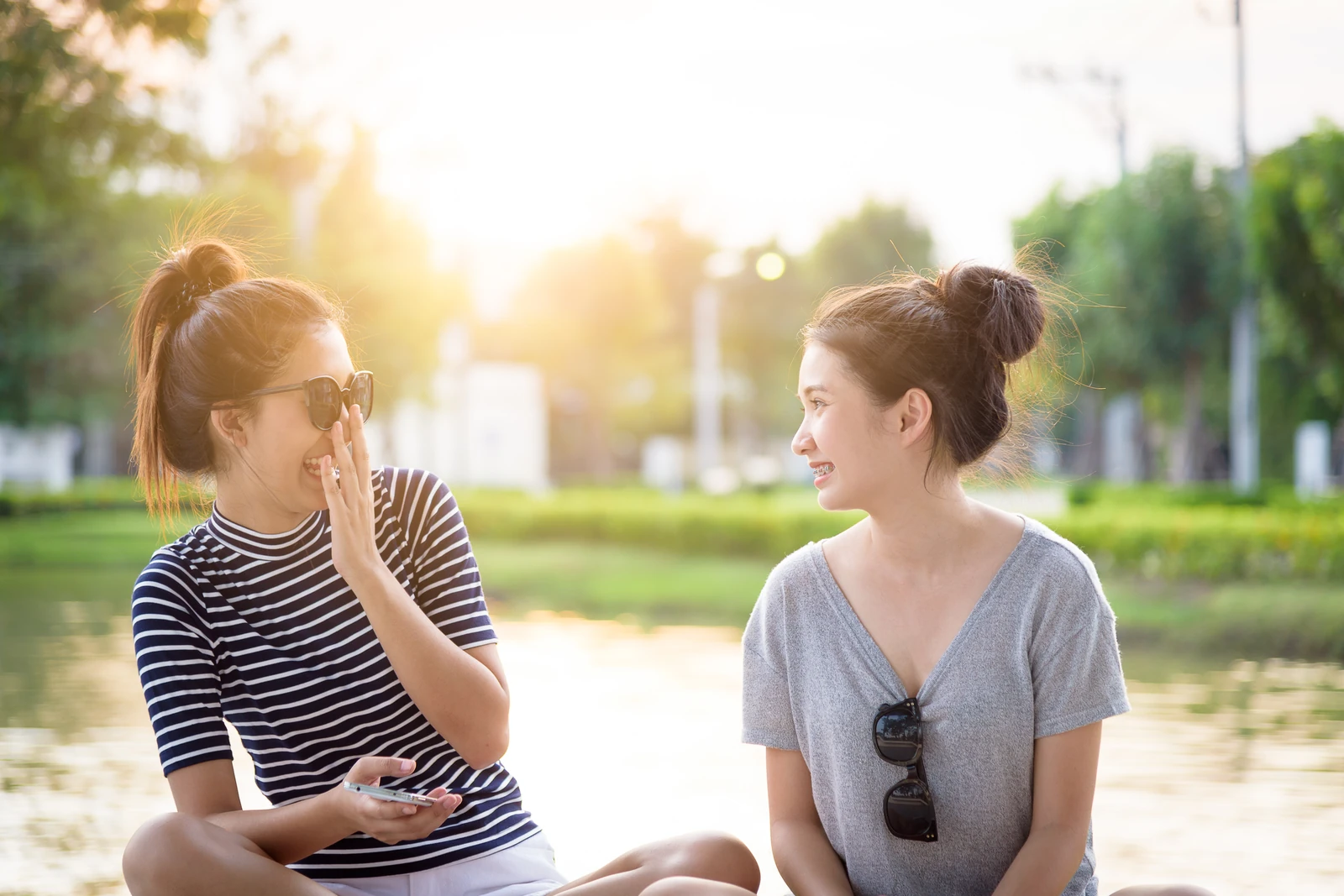 Two people talking together outdoors in warm evening light